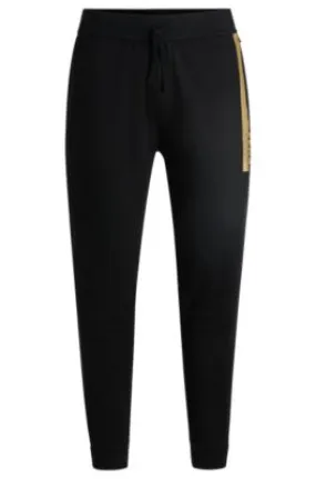 Pantalones de chándal de felpa de algodón con logo metalizado